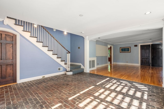 interior space with hardwood / wood-style floors and crown molding