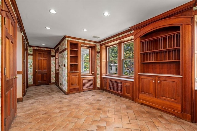 interior space featuring brick floor, recessed lighting, visible vents, and crown molding