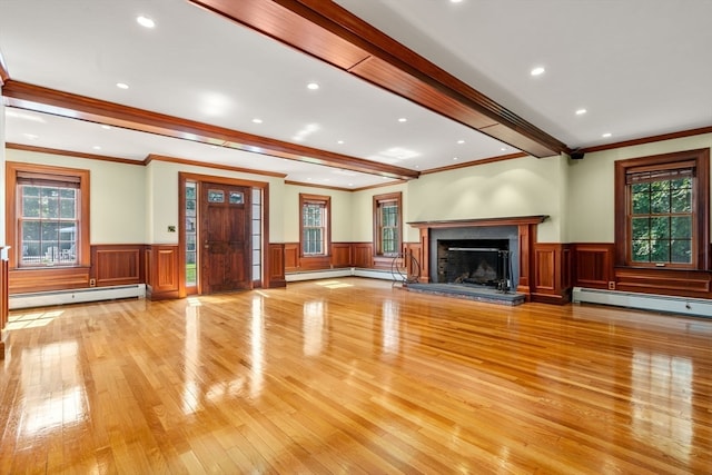 unfurnished living room with crown molding, a baseboard radiator, and light wood-type flooring