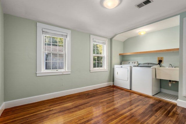 clothes washing area with wood-type flooring and sink