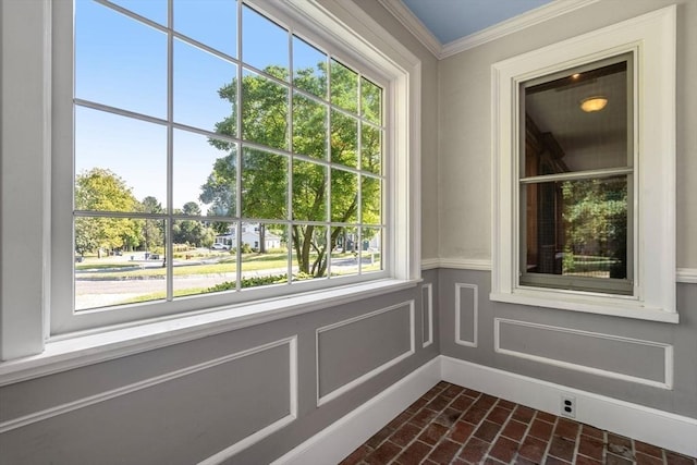 interior space featuring crown molding and a decorative wall