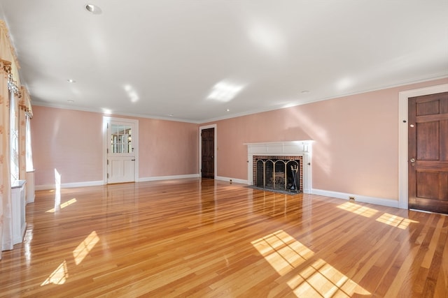 unfurnished living room featuring a fireplace, light wood-type flooring, and crown molding