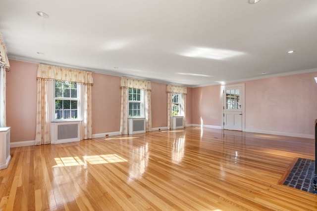 interior space with light wood-type flooring and ornamental molding