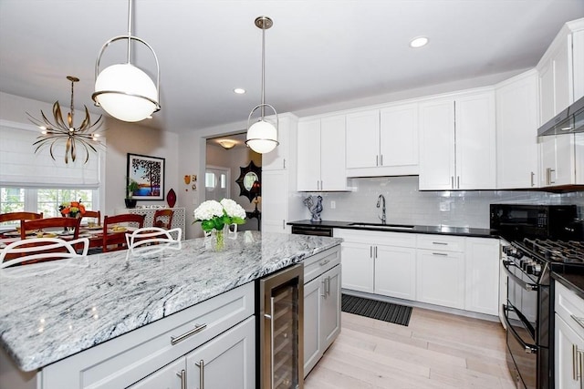 34 Split Rock Ln, Mattapoisett, MA 02739 - kitchen featuring beverage cooler, a sink, black appliances, recessed lighting, and backsplash