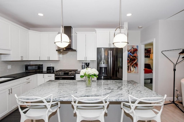 34 Split Rock Ln, Mattapoisett, MA 02739 - kitchen with appliances with stainless steel finishes, wall chimney exhaust hood, backsplash, white cabinetry, and a center island