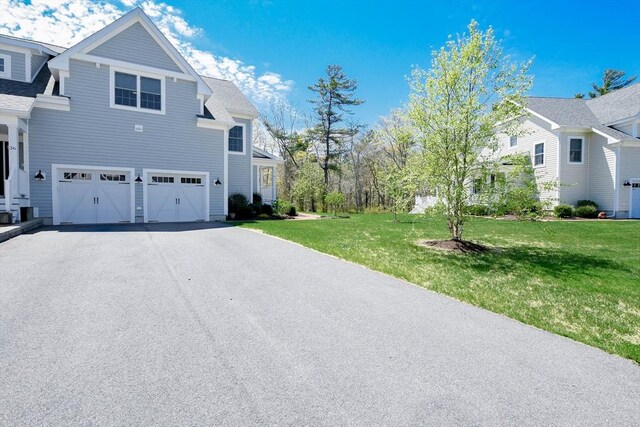 34 Split Rock Ln, Mattapoisett, MA 02739 - view of home's exterior with an attached garage, driveway, a lawn, and roof with shingles