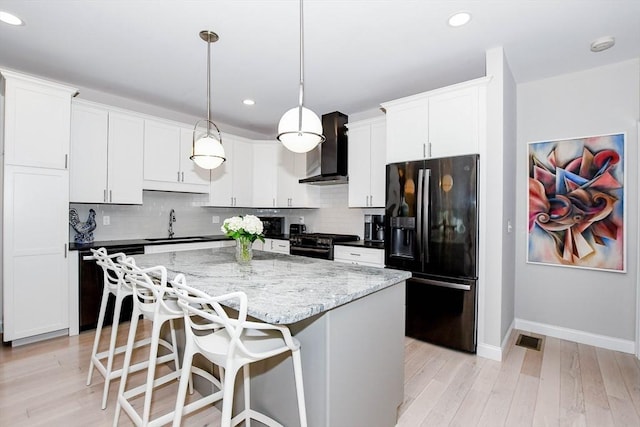 34 Split Rock Ln, Mattapoisett, MA 02739 - kitchen with black appliances, wall chimney range hood, baseboards, a center island, and backsplash