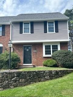 view of front of property with brick siding and a front yard
