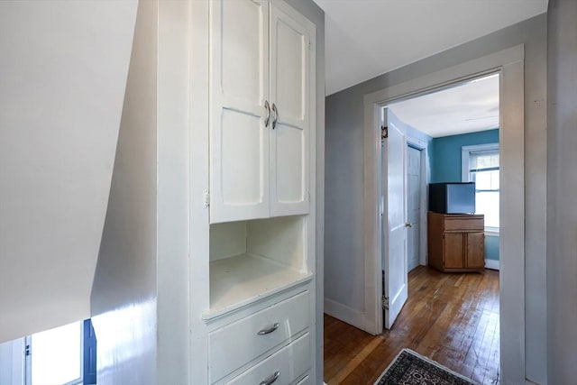 hallway with dark hardwood / wood-style floors