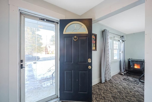 entrance foyer featuring a wood stove and plenty of natural light