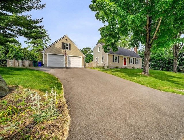 116 Woodstock Rd, Attleboro, MA 02703 - view of front facade featuring a garage, an outdoor structure, and a chimney
