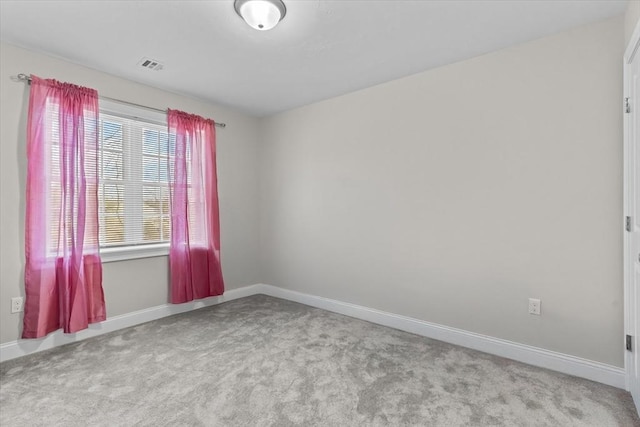 empty room with baseboards and carpet flooring