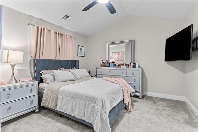 bedroom with visible vents, light carpet, lofted ceiling, baseboards, and ceiling fan