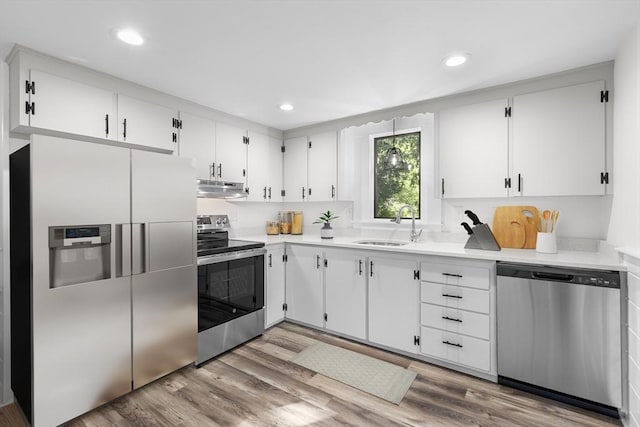 2 Pauls Way, Newbury, MA 01951 - kitchen with appliances with stainless steel finishes, range hood, light countertops, white cabinets, and recessed lighting