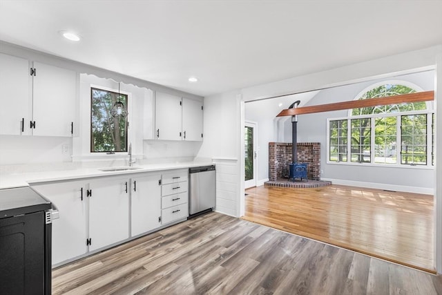 2 Pauls Way, Newbury, MA 01951 - kitchen with dishwasher, a sink, a wood stove, stove, and white cabinets