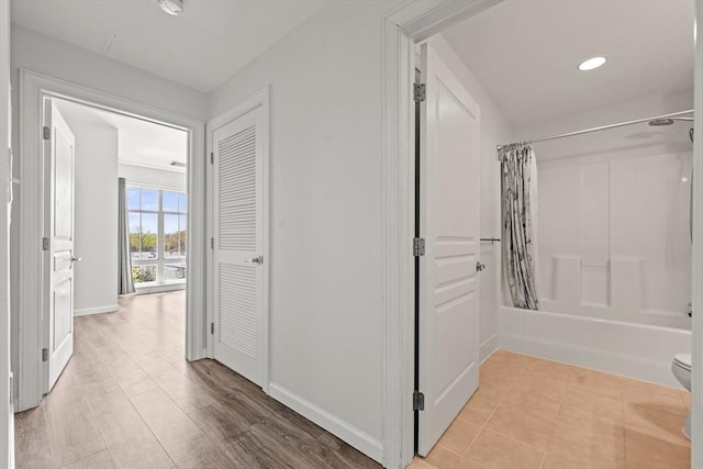 corridor with recessed lighting and baseboards