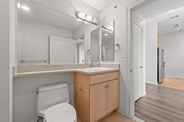 bathroom with visible vents, toilet, and vanity