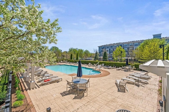 community pool featuring a patio area and fence