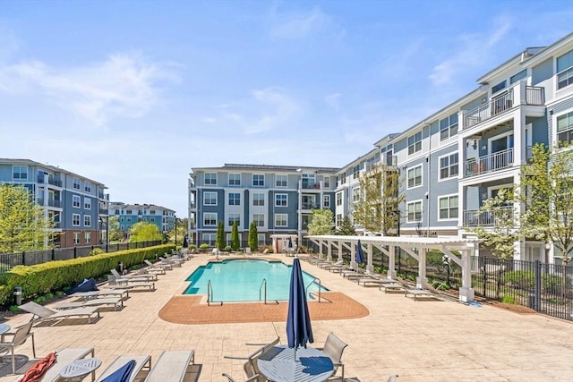 pool featuring fence and a patio area