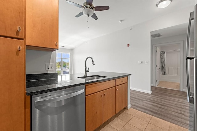 kitchen with ceiling fan, visible vents, a sink, light tile patterned floors, and stainless steel appliances