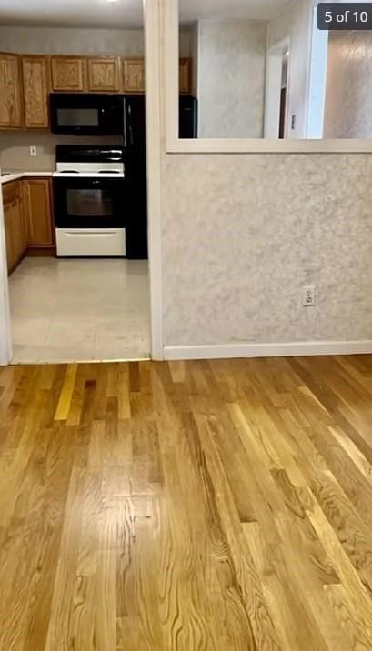 kitchen featuring white range and light hardwood / wood-style flooring