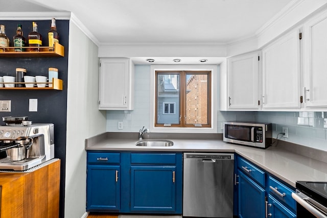 kitchen featuring blue cabinets, white cabinets, appliances with stainless steel finishes, and ornamental molding