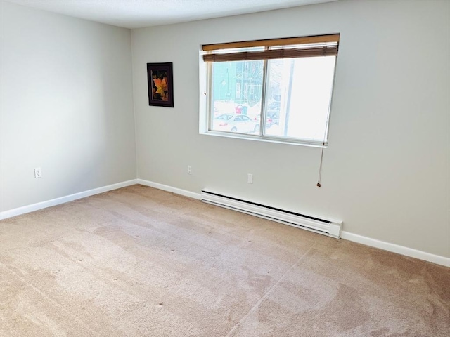 unfurnished room with a baseboard heating unit, light carpet, and baseboards