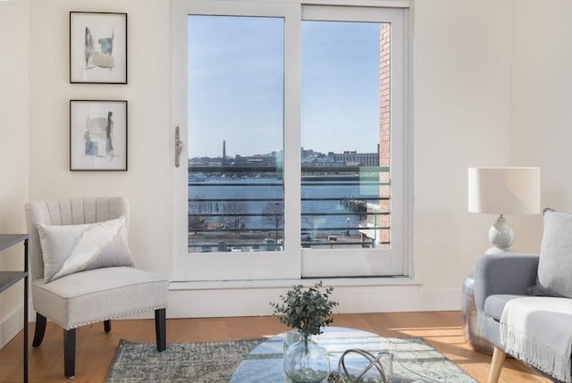 sitting room with a city view and wood finished floors