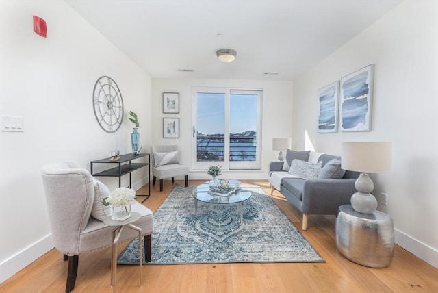 living room featuring wood finished floors and baseboards