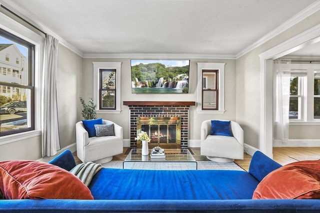 living room with crown molding, light hardwood / wood-style floors, and a brick fireplace