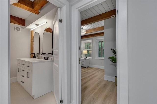 66 S W Dr, Dennis, MA 02638 - bathroom with beam ceiling, vanity, and wood finished floors