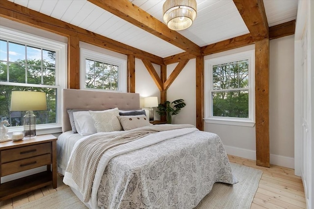 66 S W Dr, Dennis, MA 02638 - bedroom featuring multiple windows, beamed ceiling, and light wood-style flooring