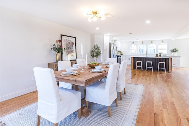 dining area featuring light wood-type flooring