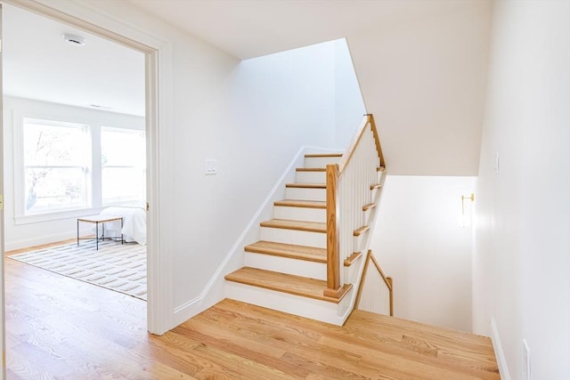 stairs with hardwood / wood-style floors