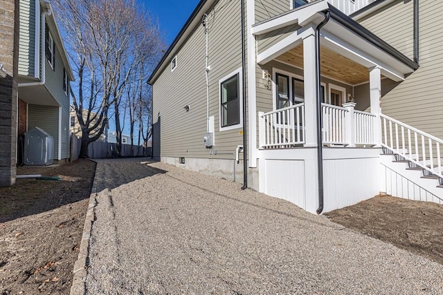 view of side of home with cooling unit and a porch