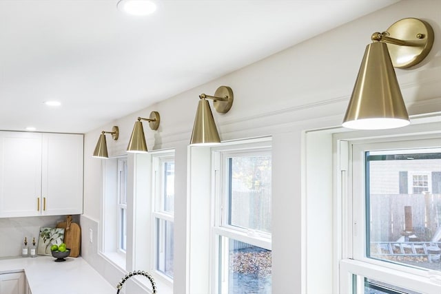 room details featuring white cabinetry and backsplash