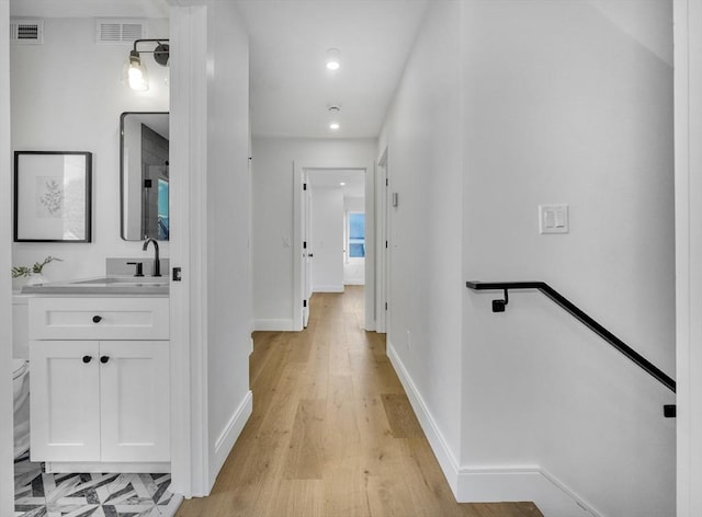 148 Myrtle Unit 1, Melrose, MA 02176 - hall featuring light wood-type flooring, visible vents, baseboards, and a sink