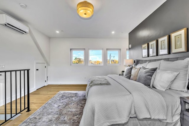 148 Myrtle Unit 1, Melrose, MA 02176 - bedroom featuring light wood-style flooring, baseboards, recessed lighting, and a wall mounted air conditioner