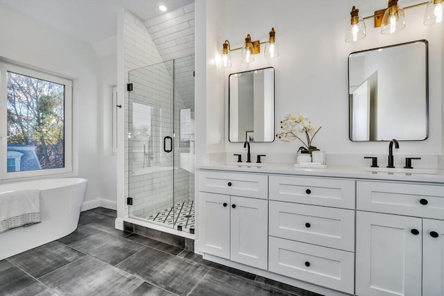 148 Myrtle Unit 1, Melrose, MA 02176 - full bathroom featuring a sink, double vanity, baseboards, a freestanding tub, and a shower stall