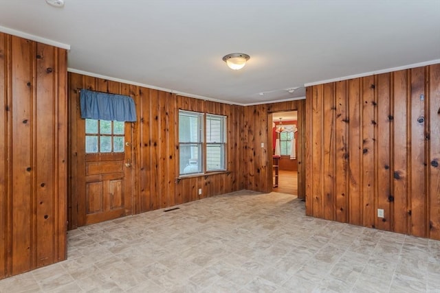 52 Maple St, Belchertown, MA 01007 - empty room featuring ornamental molding, healthy amount of natural light, wooden walls, light floors, and a smoke detector