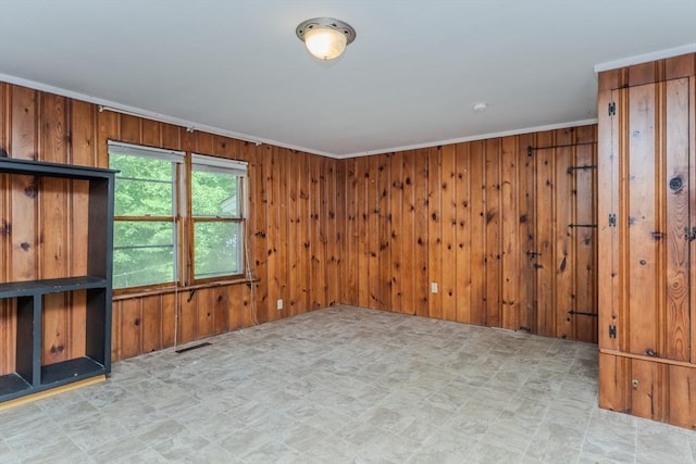 52 Maple St, Belchertown, MA 01007 - unfurnished living room featuring wooden walls, light floors, and crown molding
