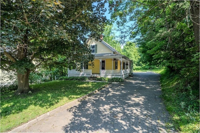 52 Maple St, Belchertown, MA 01007 - view of front of home featuring a porch, asphalt driveway, and a front yard
