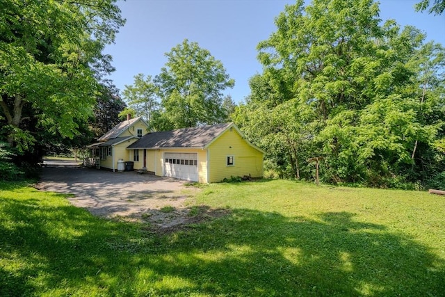 52 Maple St, Belchertown, MA 01007 - view of green lawn with an attached garage