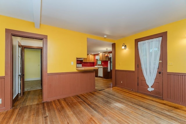 52 Maple St, Belchertown, MA 01007 - unfurnished living room featuring wood-type flooring and a wainscoted wall