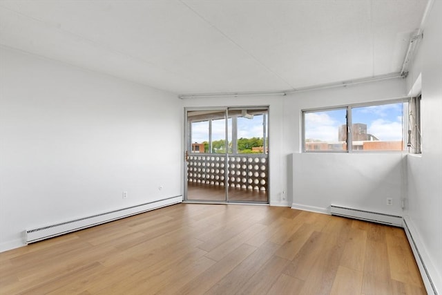 53 Melrose St Unit 7F, Melrose, MA 02176 - unfurnished room with a baseboard radiator and wood finished floors