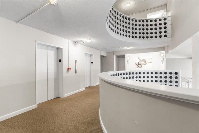 53 Melrose St Unit 7F, Melrose, MA 02176 - corridor with elevator, carpet flooring, and baseboards