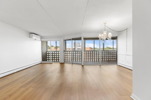 53 Melrose St Unit 7F, Melrose, MA 02176 - unfurnished room featuring an AC wall unit, a chandelier, wood finished floors, and baseboard heating