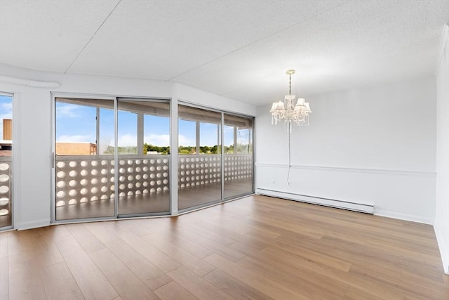 53 Melrose St Unit 7F, Melrose, MA 02176 - empty room featuring a baseboard heating unit, a chandelier, wood finished floors, and baseboards