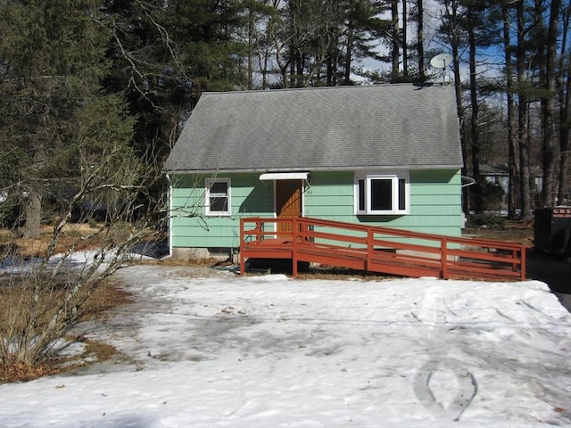 view of front of home featuring a shingled roof and central AC unit