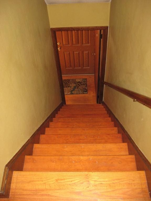 staircase with wood finished floors